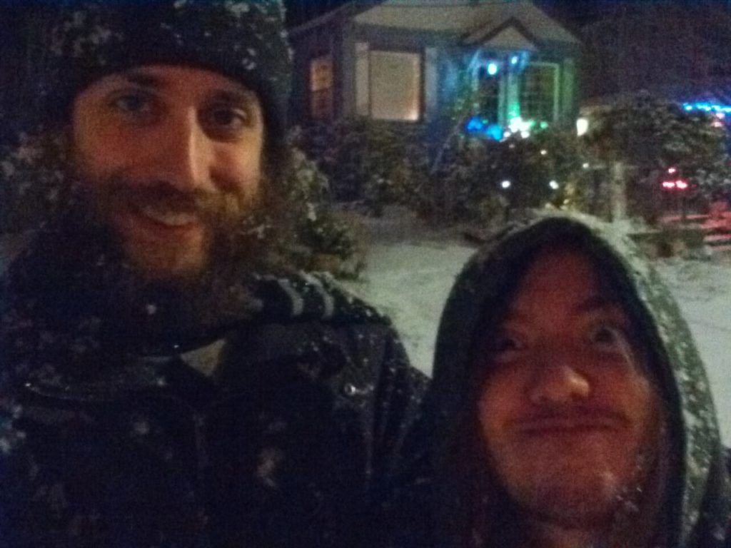 Me and Peter standing in the snowfall. I'm smiling. Peter is making an indignant face.