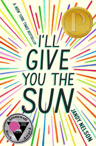 The cover to the book I'll Give You The Sun. The title text is written out in the center, with bright multicolored lines shooting out from it in all directions, like a starburst.