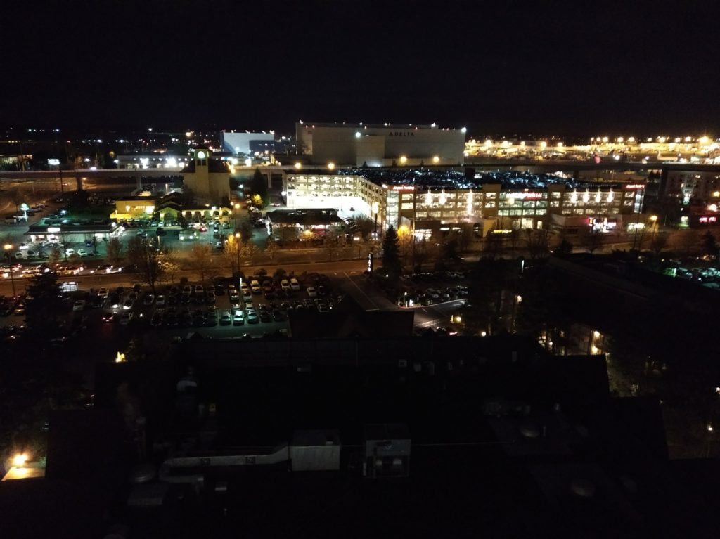 A view over the city of SeaTac at night, the darkness interspersed with the lights pouring from buildings.