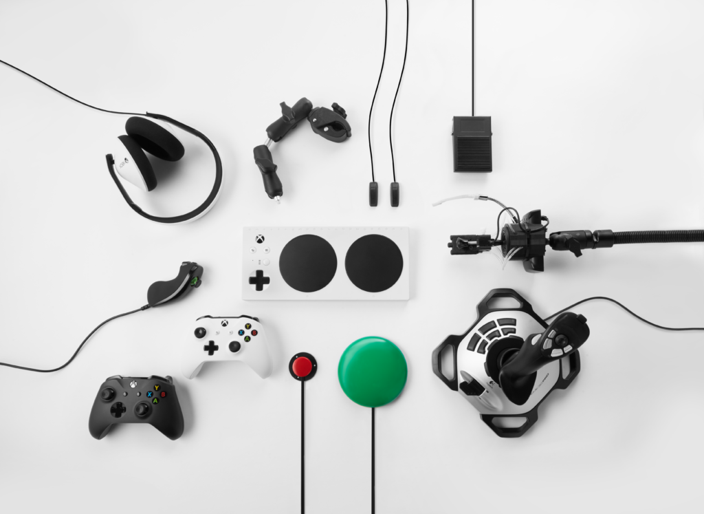 Xbox adaptive controller base surrounded by several possible add-on components.