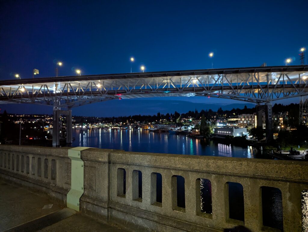 An image of the I-5 bridge over the Seattle ship canal at night.